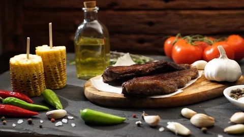 Grilled meat and vegetables on rustic wooden table. Barbecue menu Stock-Footage 115830695