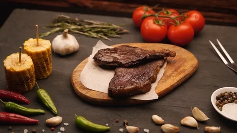 Grilled meat and vegetables on rustic wooden table. Barbecue menu Stock Footage 115830809