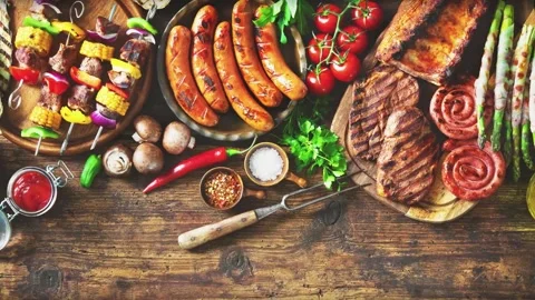 Grilled meat and vegetables on rustic wooden table Video stock 281359485