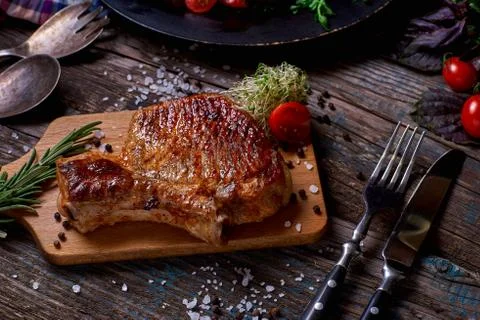 Grilled meat and vegetables on rustic wooden table Stock Photos