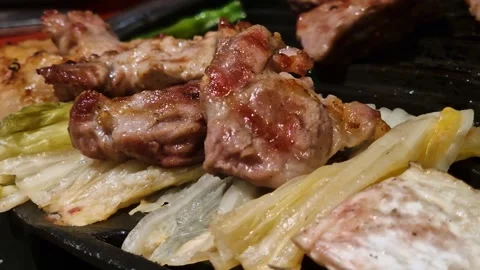 Grilled Meat on Cabbage, Korean Barbeque at Restaurant, Close Up Stock Footage 336259692