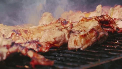 Grilled meat chunks in close-up. The meat on the fire. Roasting juicy meat steak Stock Footage 142406838
