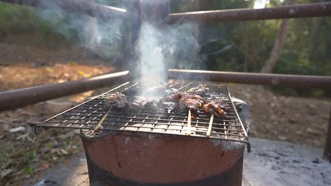 Grilled meat on fire flame for cooking in camping on hills Video stock 122883796