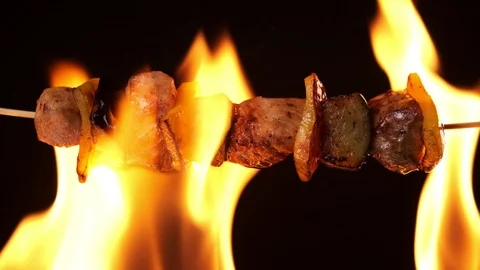 Grilled meat in the fire is smeared with a brush with sauce. Stock Footage 126587891