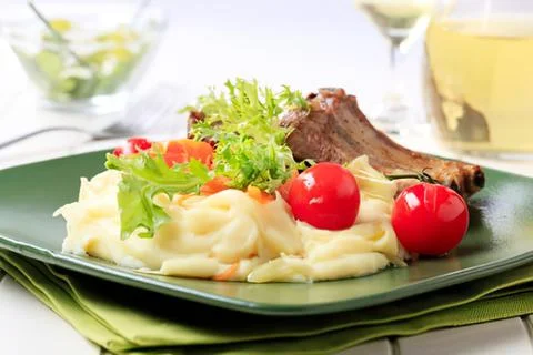 Grilled meat with mashed potatoes and cherry tomatoes Stock Photos