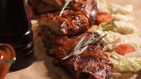 Grilled meat in a red marinade with a sprig of rosemary Stock Footage 104851747