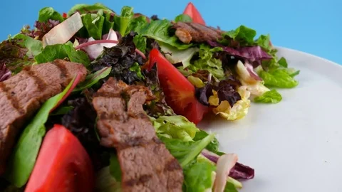 Grilled Meat salad with vegetables, blue background ready for chroma key Stock Footage 78700487