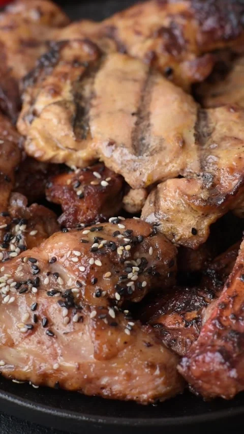 Grilled meat set featuring chicken breast, wings, and ribs seasoned with spices. Stock Footage 345108781