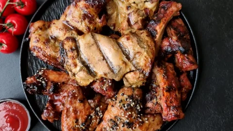 Grilled meat set featuring chicken breast, wings, and ribs seasoned with spices. Stock Footage 345108995