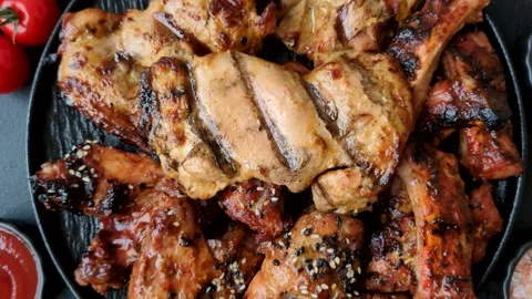 Grilled meat set featuring chicken breast, wings, and ribs seasoned with spices. Stock Footage 345109015