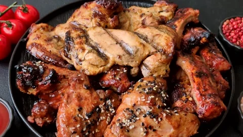 Grilled meat set featuring chicken breast, wings, and ribs seasoned with spices. Stock Footage 345109019