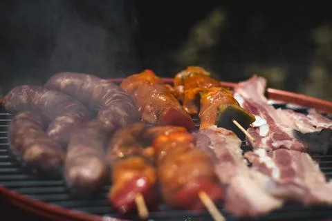 Grilled meat with skewers and meat in the barbeque Stock Photos