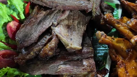 Grilled Meat Slices Served with Vegetables at Asian Street Food Stall Stock Footage 330281091