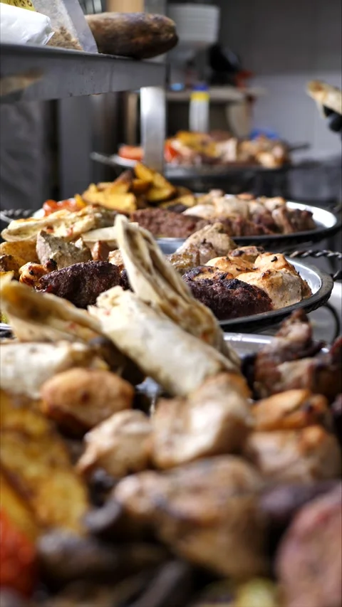 Grilled meat with vegetables on a plate before serving Stock Footage 310343568