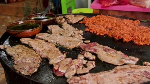 Grilled Mexican Beef Steak And Chorizo Sausage On Traditional Round Griddle Video stock 345181316