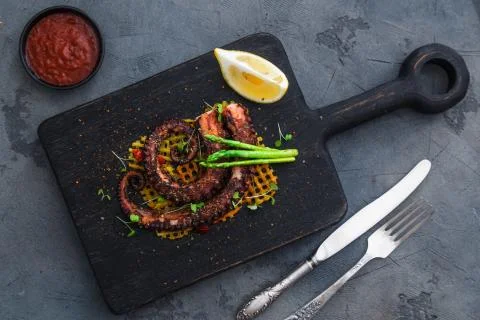 Grilled octopus with vegetables Stock Photos