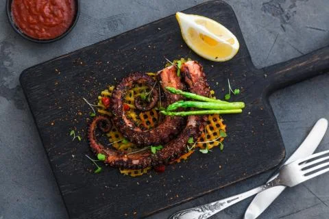 Grilled octopus with vegetables Stock Photos