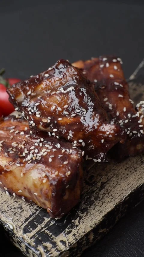 Grilled or bbq pork ribs with sauce, a food prepared for dinner. Grilled ribs Stock Footage 321615325