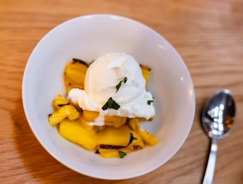 Grilled pineapple slices complemented with vanilla ice cream Stock Photos