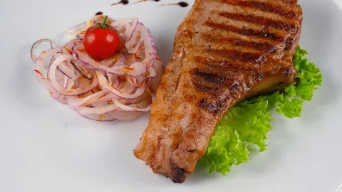 Grilled pork chop, served in Restaurant Stock Footage 79713241