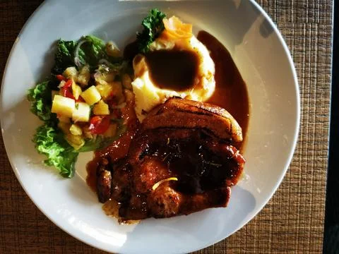 Grilled Pork Chops with Mashed Potatoes and Fresh Salad Stock Photos