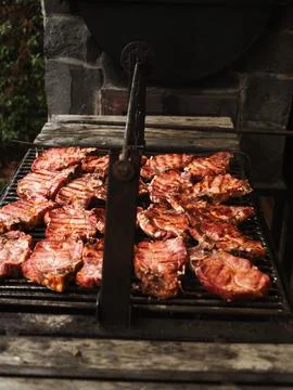 Grilled pork chops sizzle on a rustic barbecue grill Stock Photos