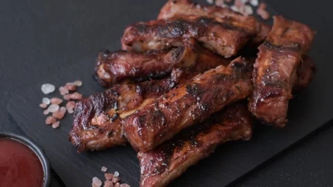 Grilled pork or beef ribs seasoned with salt and spices, served in sauce. Grille Stock Footage 345108756