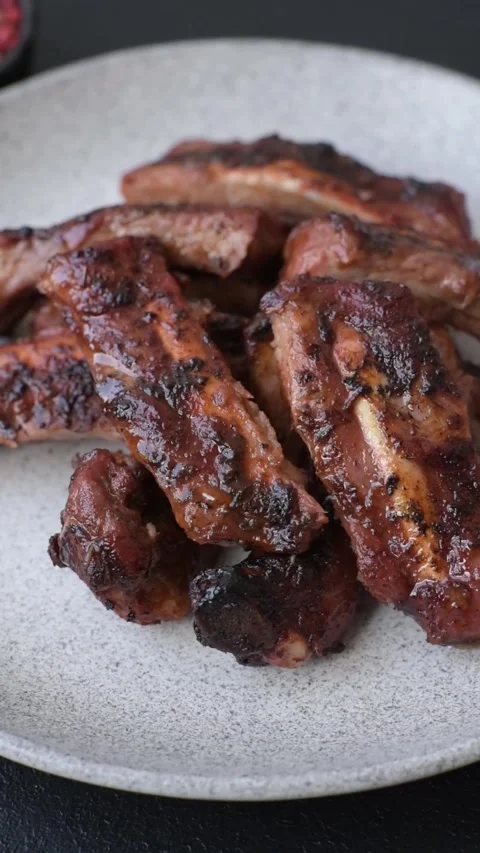 Grilled pork or beef ribs seasoned with salt and spices, served in sauce. Grille Stock Footage 345108761