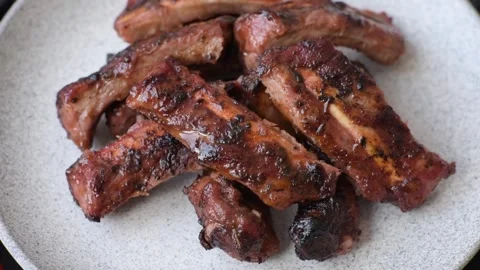 Grilled pork or beef ribs seasoned with salt and spices, served in sauce. Grille Stock Footage 345108762
