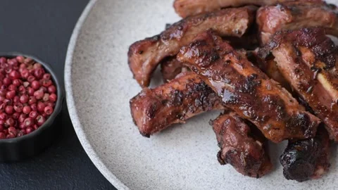 Grilled pork or beef ribs seasoned with salt and spices, served in sauce. Grille Stock Footage 345108771