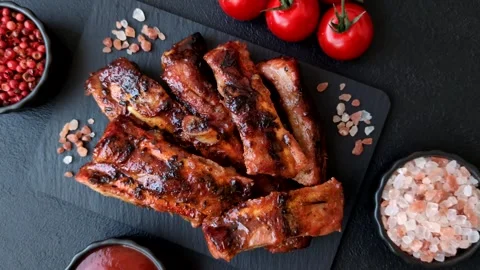 Grilled pork or beef ribs seasoned with salt and spices, served in sauce. Grille Stock Footage 345108826