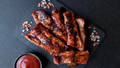 Grilled pork or beef ribs seasoned with salt and spices, served in sauce. Grille Stock Footage 345108828