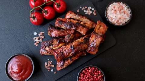 Grilled pork or beef ribs seasoned with salt and spices, served in sauce. Grille Stock Footage 345108836