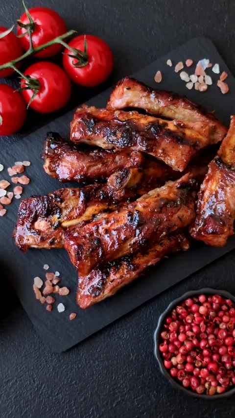 Grilled pork or beef ribs seasoned with salt and spices, served in sauce. Grille Stock Footage 345108846