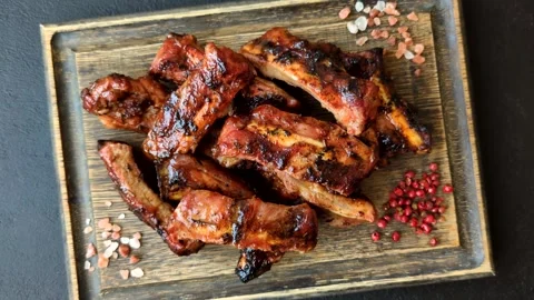 Grilled pork or beef ribs seasoned with salt and spices, served in sauce. Grille Stock Footage 345108861