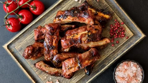 Grilled pork or beef ribs seasoned with salt and spices, served in sauce. Grille Stock Footage 345108862
