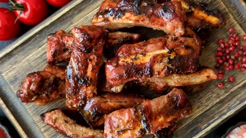 Grilled pork or beef ribs seasoned with salt and spices, served in sauce. Grille Stock Footage 345108868