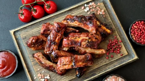 Grilled pork or beef ribs seasoned with salt and spices, served in sauce. Grille Stock Footage 345108874