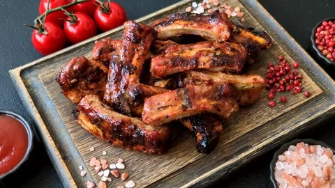 Grilled pork or beef ribs seasoned with salt and spices, served in sauce. Grille Stock Footage 345108876