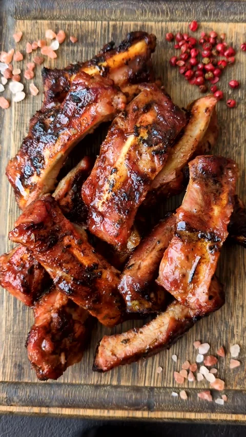 Grilled pork or beef ribs seasoned with salt and spices, served in sauce. Grille Stock Footage 345108880