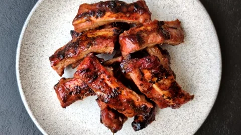 Grilled pork or beef ribs seasoned with salt and spices, served in sauce. Grille Stock Footage 345108887