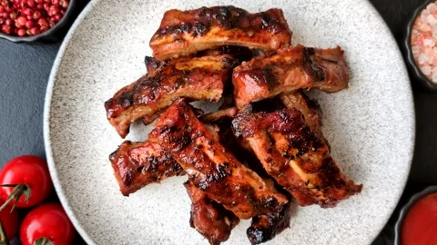 Grilled pork or beef ribs seasoned with salt and spices, served in sauce. Grille Stock Footage 345108919