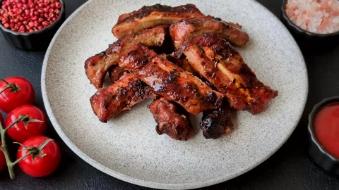 Grilled pork or beef ribs seasoned with salt and spices, served in sauce. Grille Stock Footage 345108964