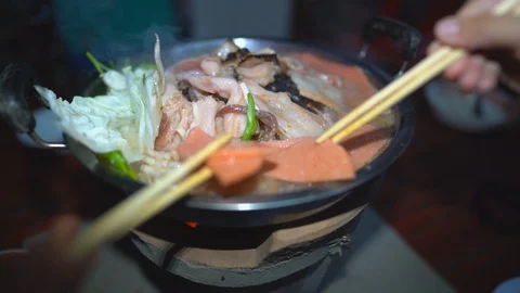 Grilled pork on pan, close up meat slice on hot pan, vegetable in hot soup Stock-Footage 129113861