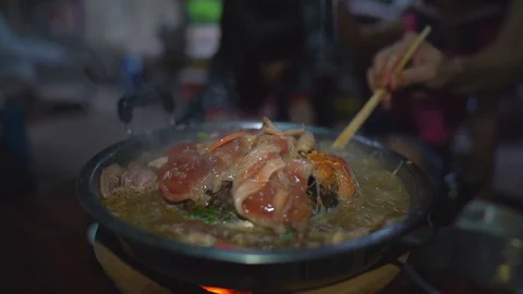 Grilled pork on pan, close up meat slice on hot pan, vegetable in hot soup Stock-Footage 129114382