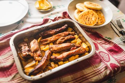 Grilled pork ribs on table inside oven aluminum container with venezuelan are 写真素材
