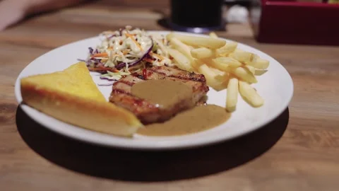 Grilled pork steak with black pepper gravy served with crispy french fries,.. Stock Footage 342781932