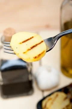 Grilled potato on a fork Stock Photos