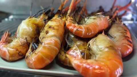 Grilled prawns with charred shells and vibrant orange color Stock Footage 314708162