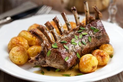 Grilled Rack of Lamb chops with potatoes on a plate Stock Photos